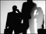 Video Clip - Human figures depicted in black in front of a white background; people holding brief cases while on the phone