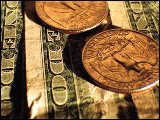 Video Clip - Several quarters laid out on a few dollar bills