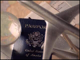 Video Clip - Travelling depicted by passport, plane ticket, metallic toy place and a globe