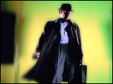 Video Clip - Man with a hat and a brief case answering his cell phone in slow motion