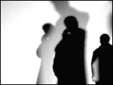 Video Clip - Human figures depicted in black in front of a white background; people talking on the phone