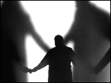 Video Clip - Human figures depicted in black in front of a white background; people holding hands