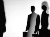 Video Clip - Human figures depicted in black in front of a white background; waiting with brief cases