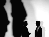 Video Clip - Human figures depicted in black in front of a white background; informal discussion during break