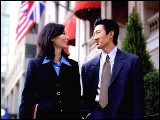 Video Clip - A man and woman, both of Asian decent, in business attires walking outside an embassy building