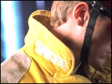 Video Clip - A fire fighter looking down and then into the camera