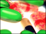 Video Clip - Red, green, black and yellow colored capsules on white surface